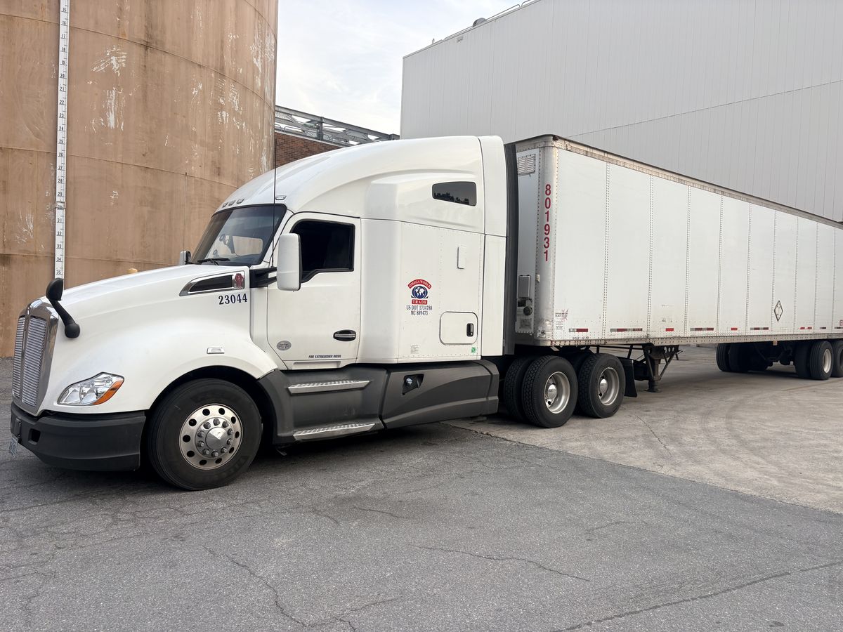 White Kenworth truck 23044 hooked to a dry van trailer