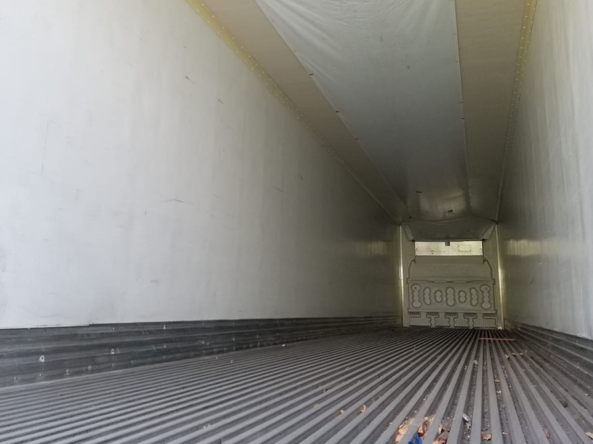 Empty interior of a refrigerated trailer with ribbed floor and air chute