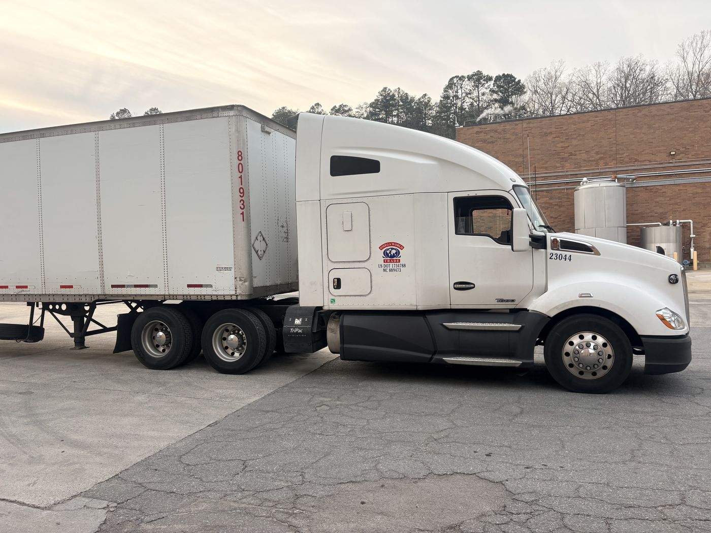 Omega World Trade truck 23044 with a dry van trailer, company logo and USDOT number on the cab